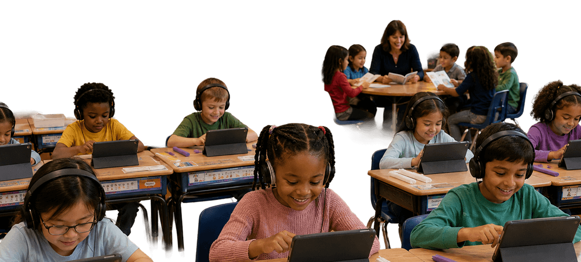 A teacher reading with a small group of students while other students use tablets at their desks