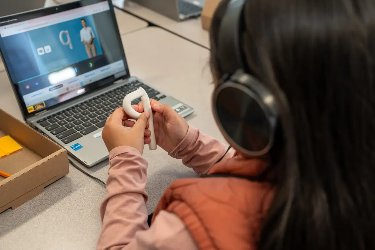 Learning Letters program – child with laptop and headphones